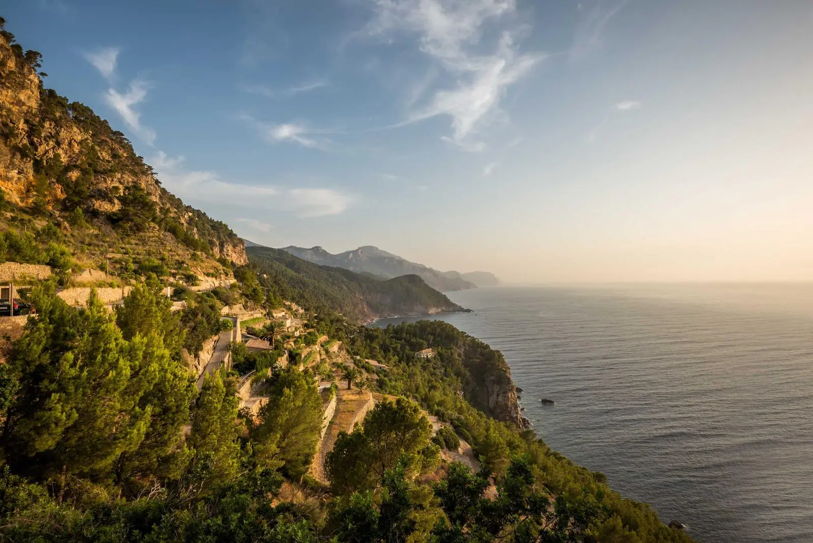 Warm evening sun over a wide coastal landscape